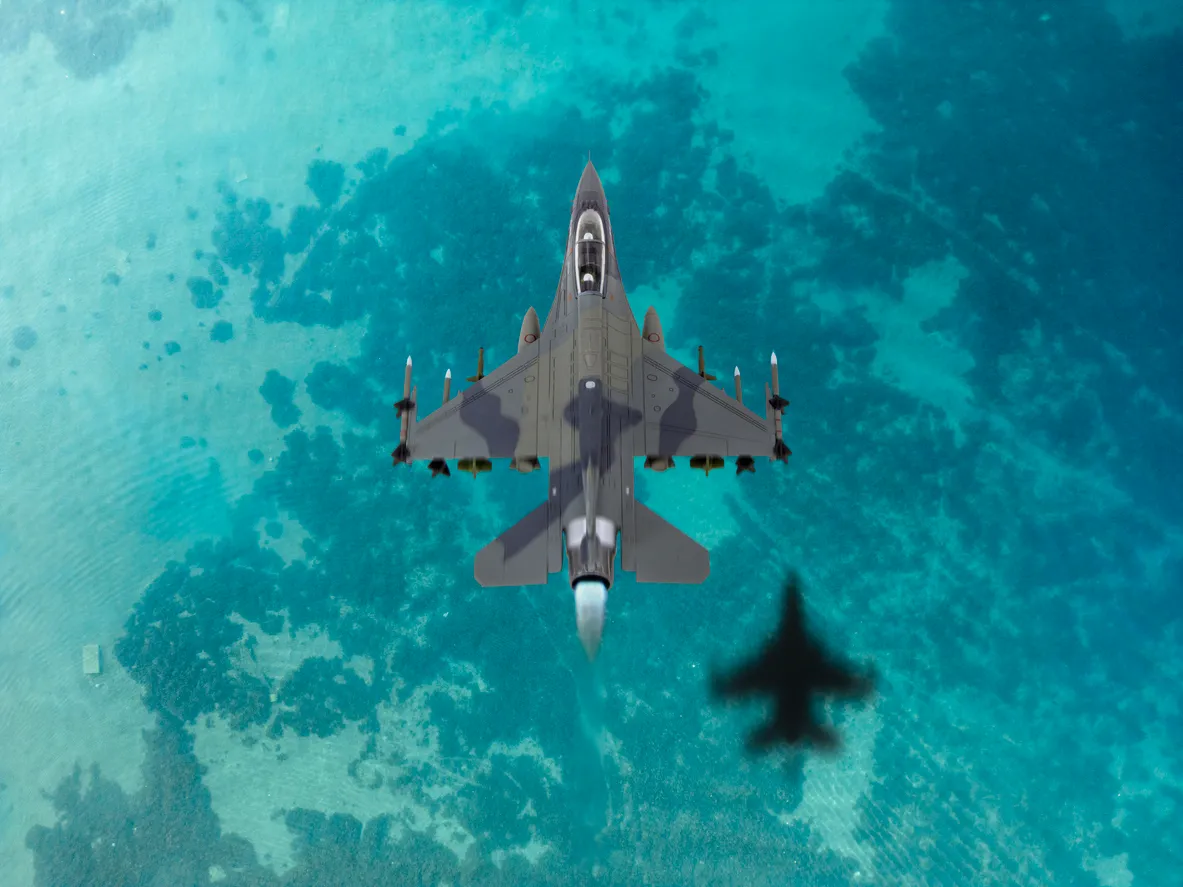Military jet flying low over the ocean